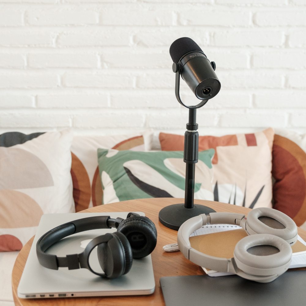 Podcast mic on table with two laptops.