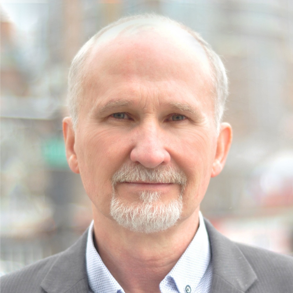 Headshot of man with grey hair and beard.