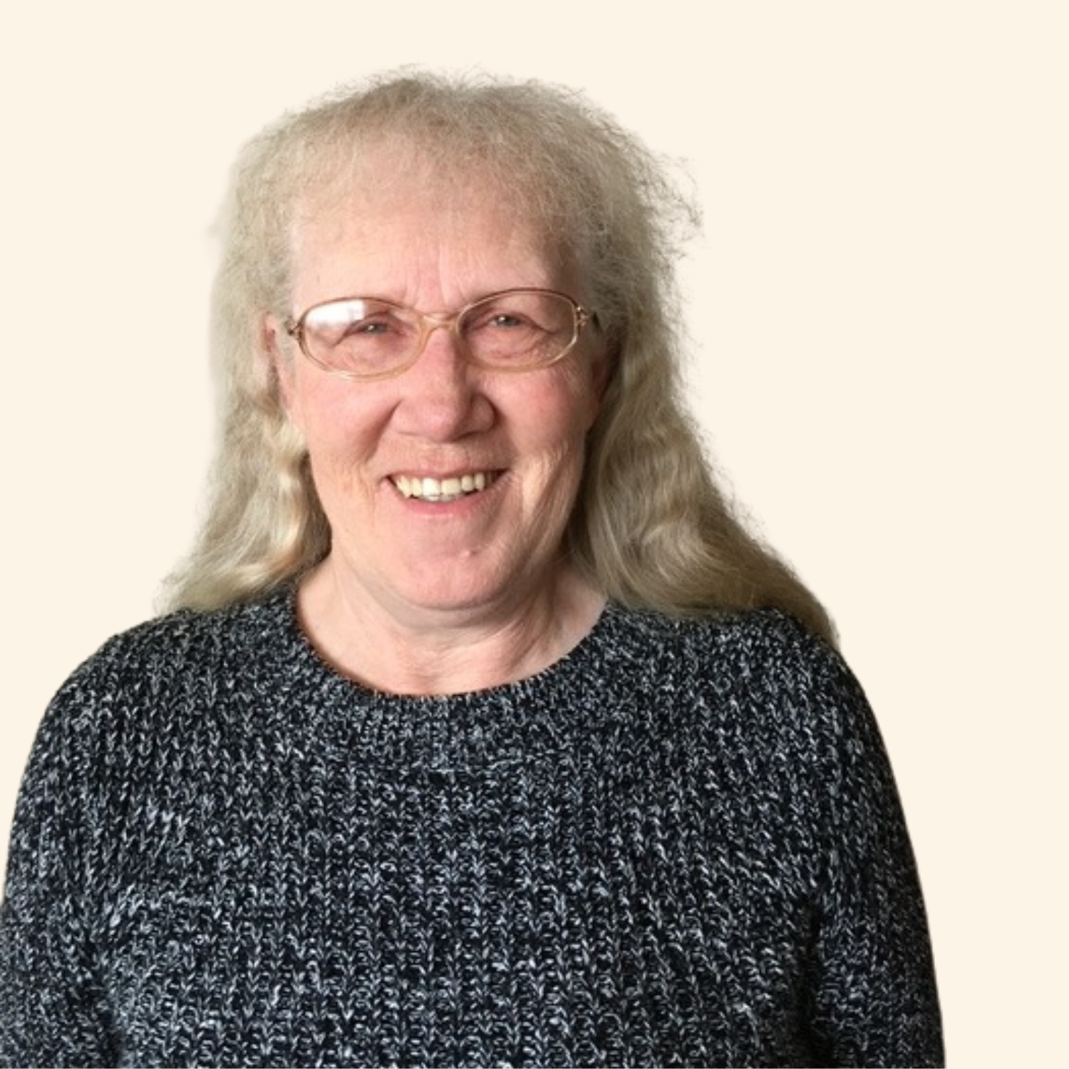 Headshot of woman wearing glasses and a grey blazer with white shirt.